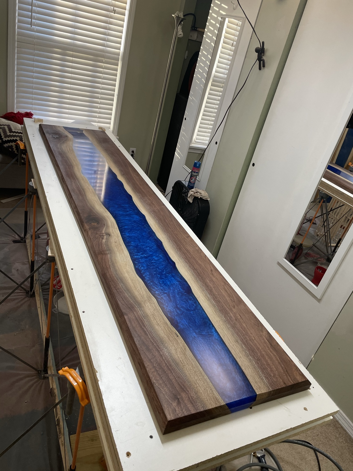 Full-length view of the completed walnut and blue resin tabletop