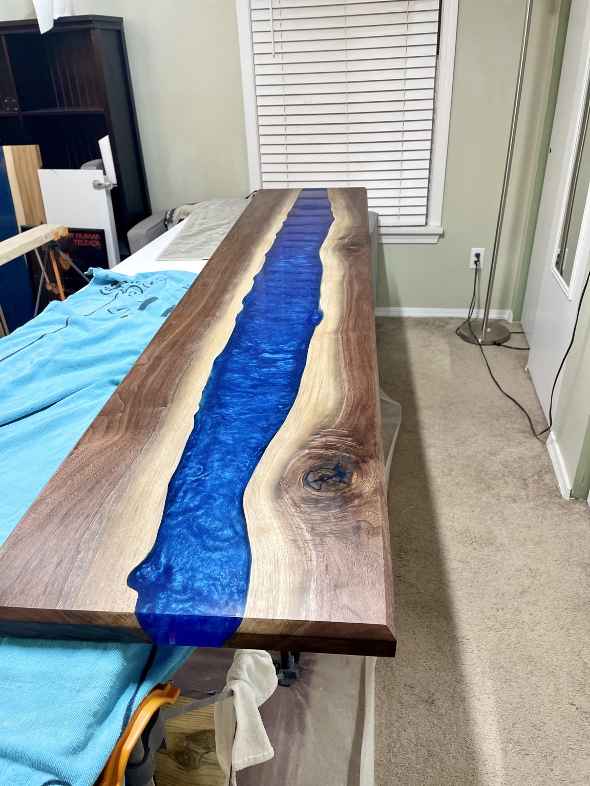 Completed walnut and deep blue resin river tabletop