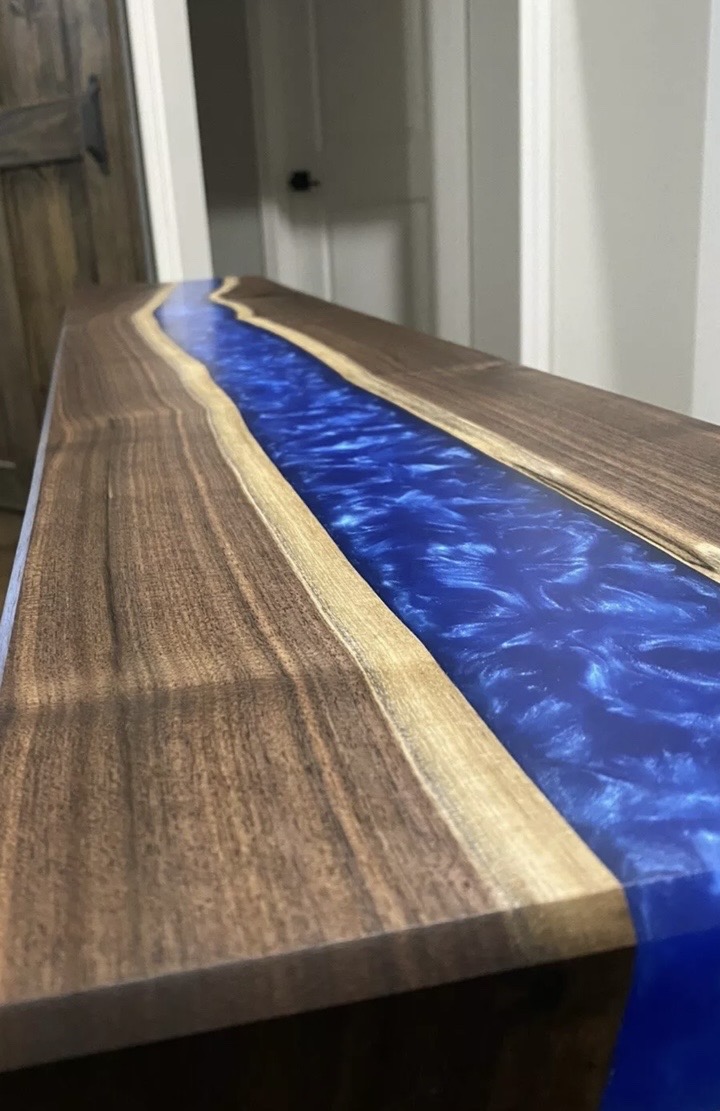 Client reference photograph showing the walnut live edge and blue resin